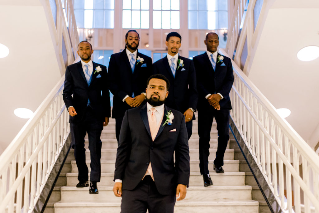 Groomsmen walking down the stairs for the photo shoot.